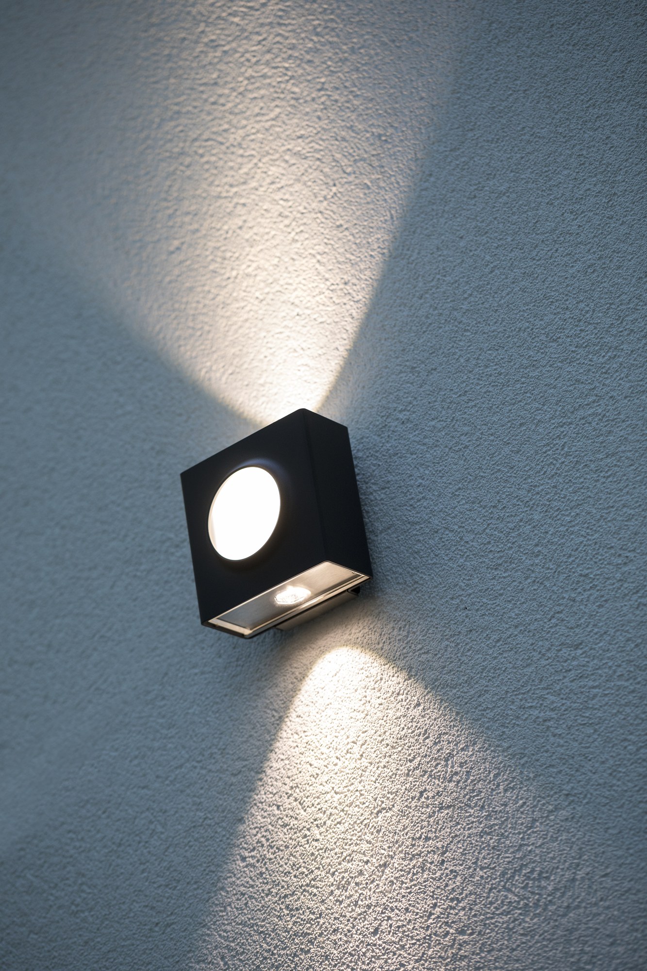 Applique extérieure Klint LED up and down par Roger Pradier applique extérieure Klint noir velours à cercle lumineux, éclairage haut et bas sur une façade enduite