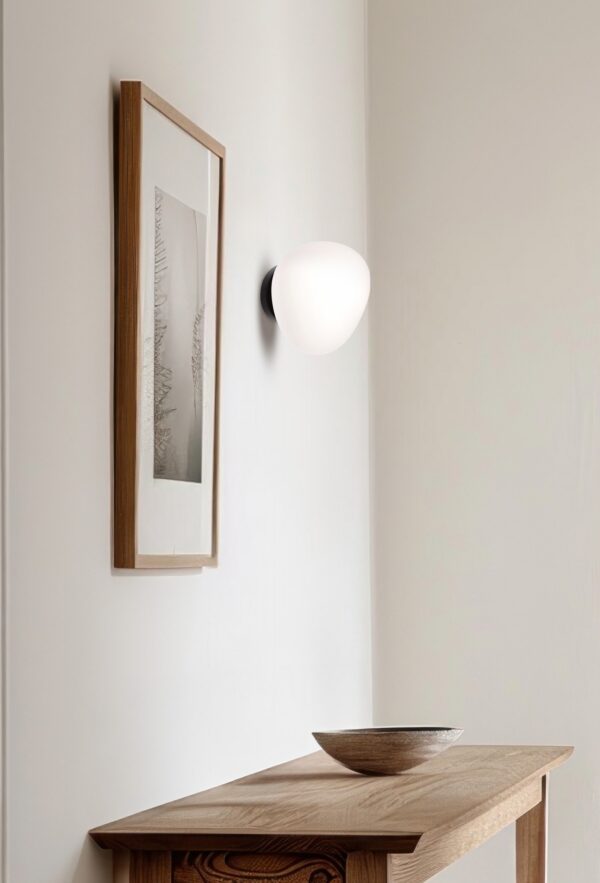applique murale galet blanc au dessus d une console en bois