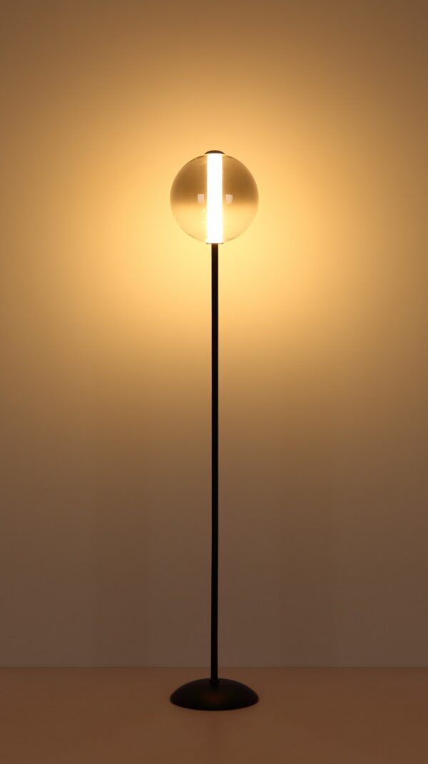 lampadaire boule verre fumé allumé, lumière chaude sur le mur