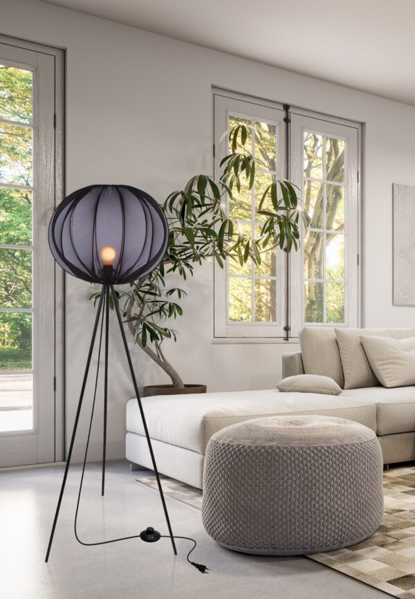 lampadaire globe noir allumé dans un salon lumineux avec pouf