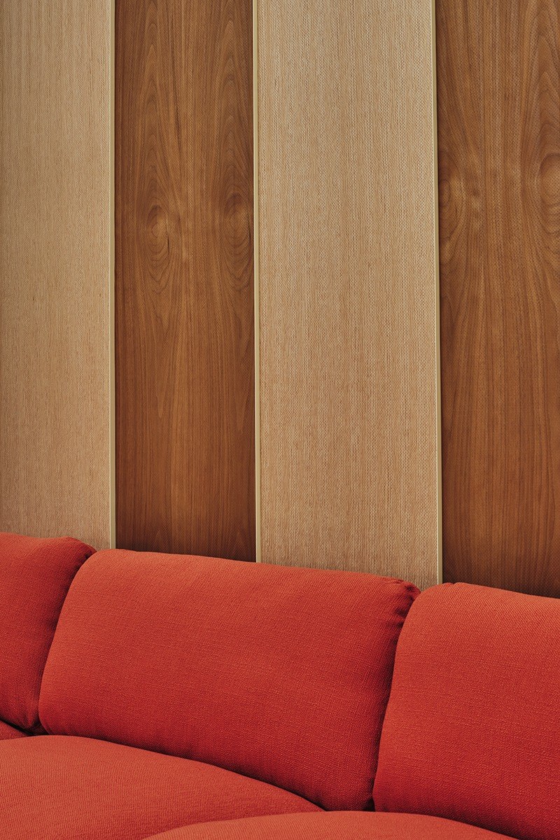 Panneau acoustique mural Woody par Slalom, placage de bois panneau acoustique bois Slalom Woody en noyer et chene au dessus d un canape orange