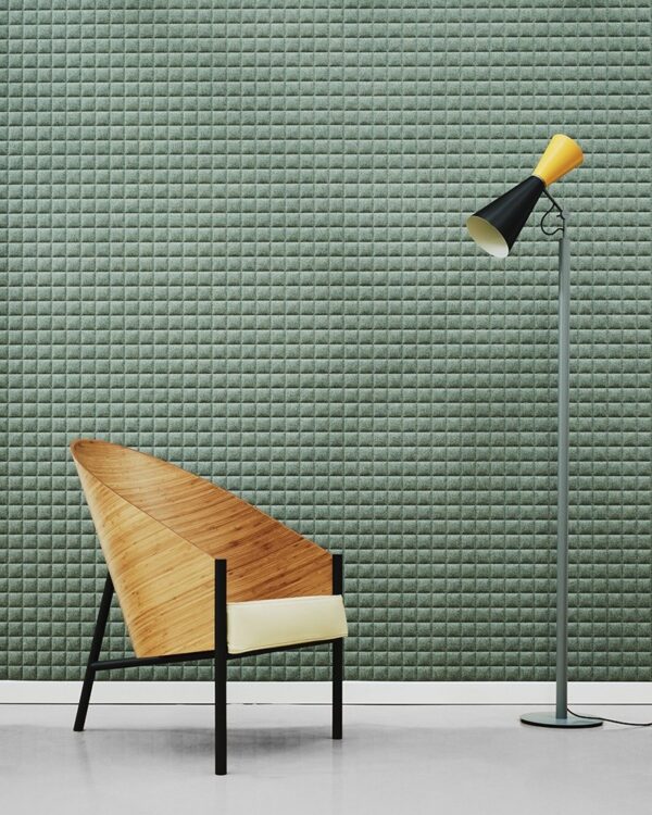 panneau acoustique quadrillé Slalom Square vert sauge derriere un fauteuil et un lampadaire