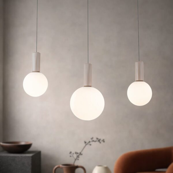 suspension barre 3 globes trois globes opale devant un mur gris