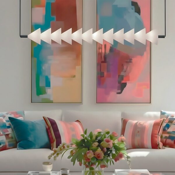 suspension horizontale Boga allumée au dessus du canapé devant deux grands tableaux colorés dans un salon